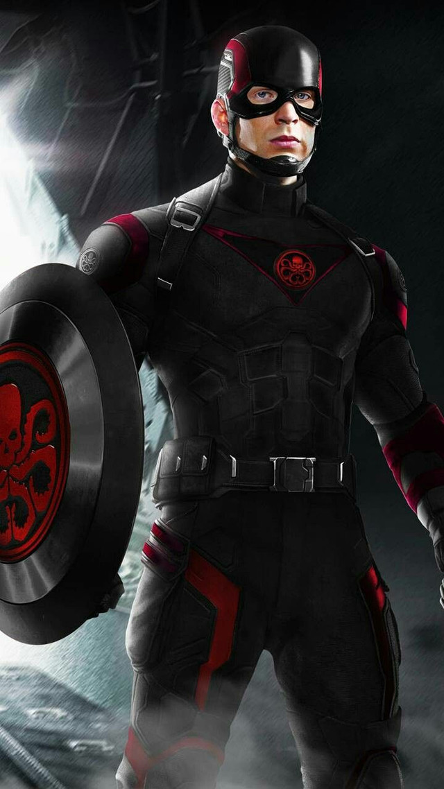 A soldier in black and red tactical armour holding a dark shield stamped with a red hydra