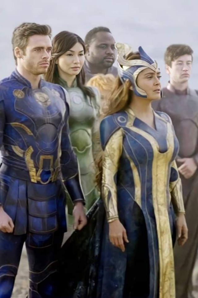 Eternals movie poster showing the team assembled before the dormant Celestial Tiamut