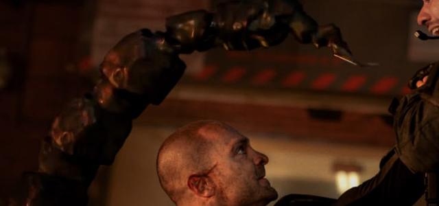 Scorpion's mechanical stinger looms over a guard's face during the Damage Control facility raid.