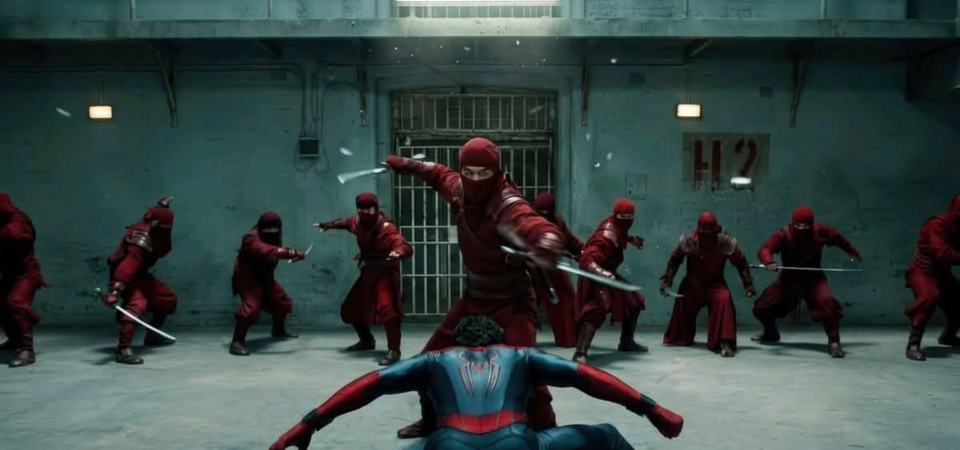 Spider-Man crouches surrounded by a ring of Jean's mind-controlled Hand ninjas.
