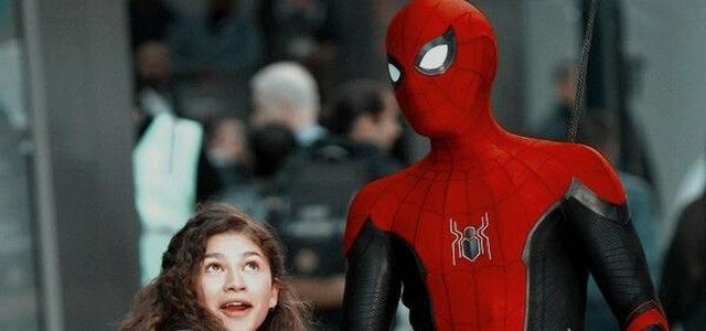 Spider-Man in his red and black suit stands beside MJ on a crowded city street