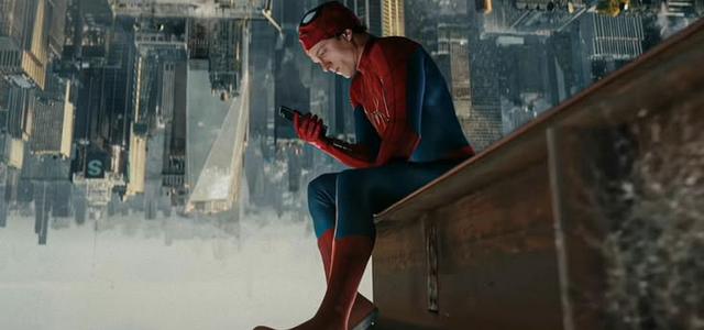 Spider-Man perched on a rooftop ledge overlooking the city at dusk